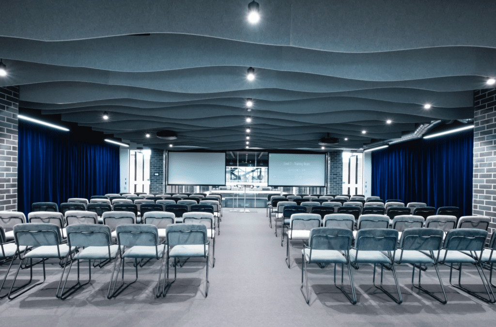 The 'Caribbean Park Training Room' a Large 80 Person, Classroom Style Training Room With Two Large Projectors and Speaker Presentation Stand For Hire at Waterman Caribbean Park Coworking Centre in Scoresby, VIC
