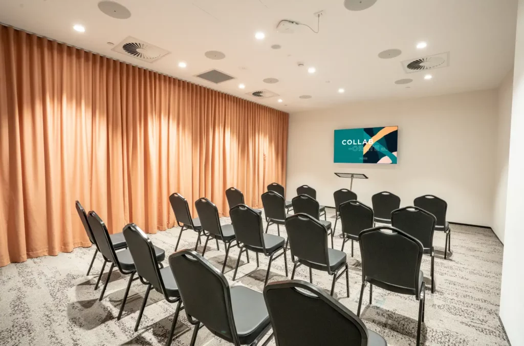 The 'Mullum Mullum Training', a 25 Person Capacity Training Room With 55" Display Screen and Presenter Stand For Hire at Waterman Eastland Coworking Centre in Ringwood, VIC